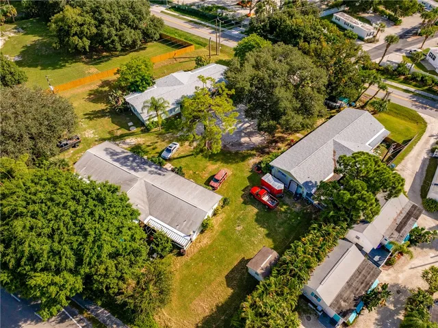 an aerial view of a house with a yard and lake view
