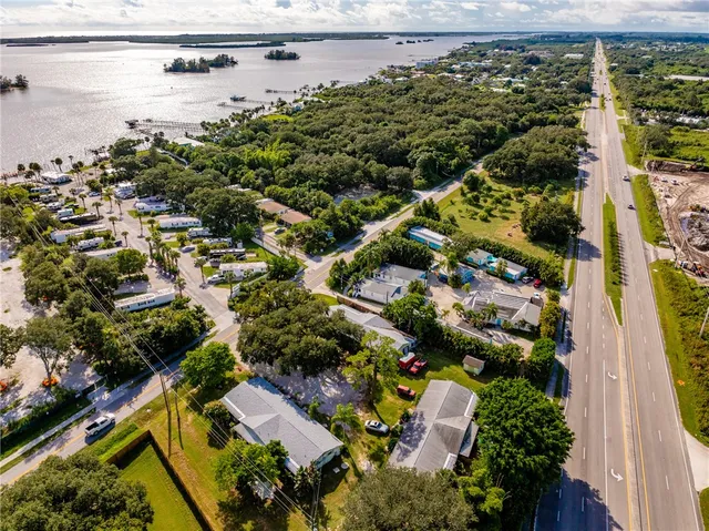 an aerial view of residential houses with outdoor space and street view