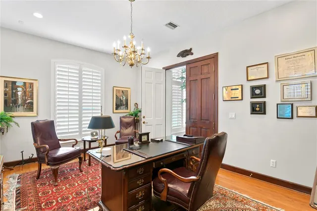 a view of a dining room with furniture wooden floor and chandelier