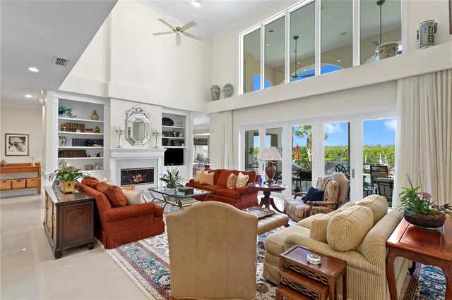 a living room with furniture fireplace and a large window