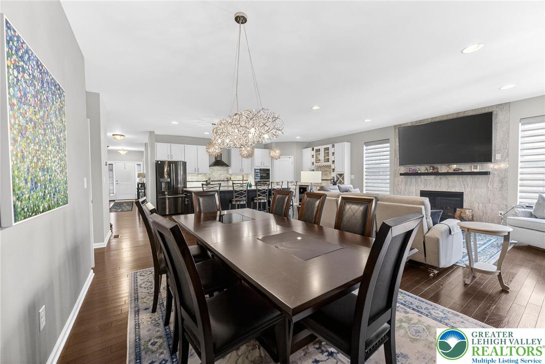 3465 Treeview Drive Emmaus, PA 18049 - Photo 15 of 38 a view of a dining room and livingroom with furniture wooden floor a chandelier