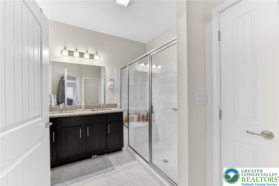 3465 Treeview Drive Emmaus, PA 18049 - Photo 23 of 38 a bathroom with a double vanity sink and mirror