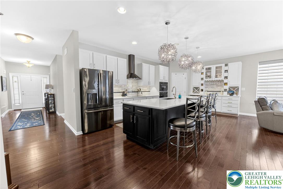 3465 Treeview Drive Emmaus, PA 18049 - Photo 4 of 38 a kitchen with stainless steel appliances a dining table chairs stove and refrigerator