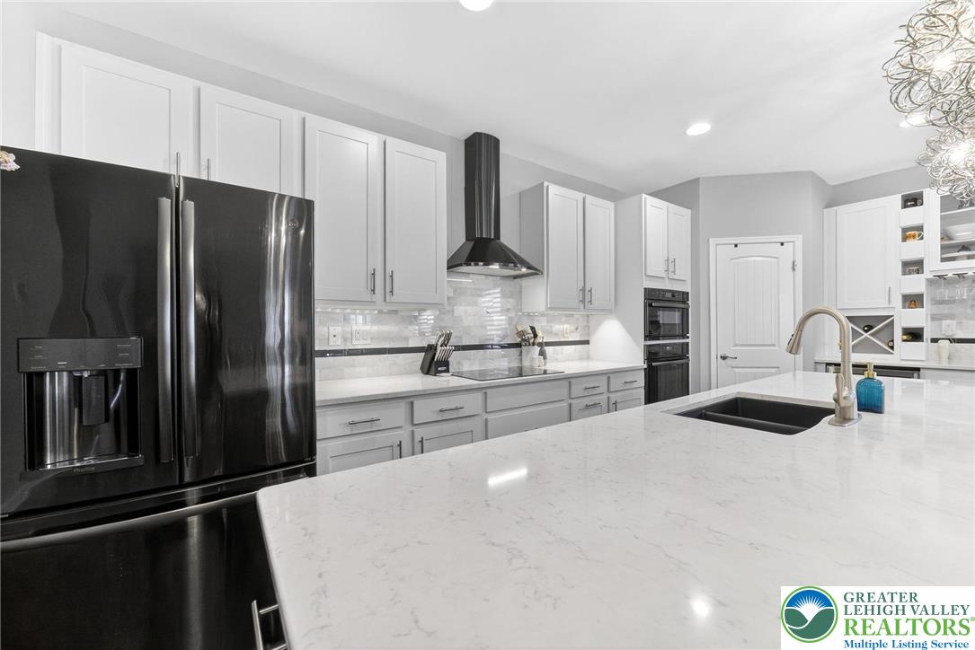3465 Treeview Drive Emmaus, PA 18049 - Photo 6 of 38 a kitchen with stainless steel appliances kitchen island a refrigerator sink and stove