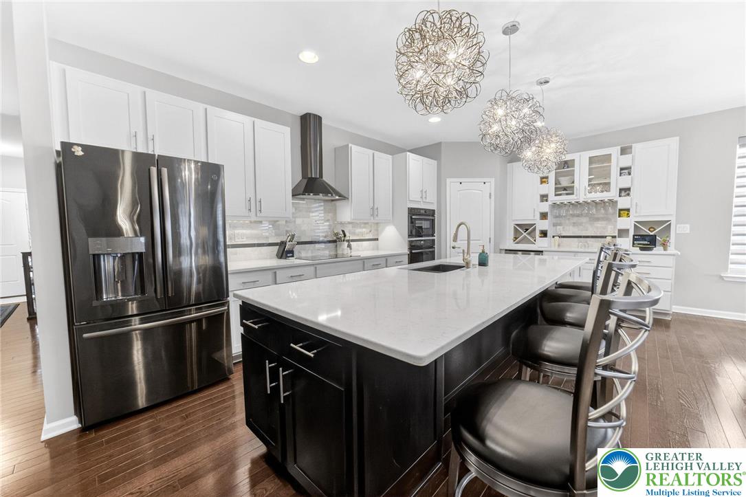3465 Treeview Drive Emmaus, PA 18049 - Photo 7 of 38 a kitchen with kitchen island granite countertop a sink cabinets and stainless steel appliances