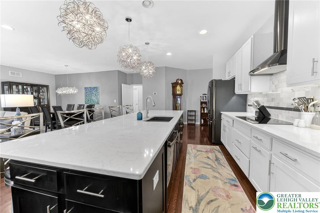 3465 Treeview Drive Emmaus, PA 18049 - Photo 8 of 38 a large kitchen with kitchen island a stove a sink a dining table and chairs