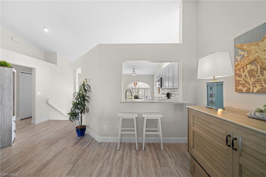 13120 Castle Harbour Drive, Unit N4 Naples, FL 34110 - Photo 11 of 36 a living room with furniture and a wooden floor