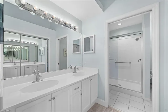 a bathroom with a sink double vanity and a mirror