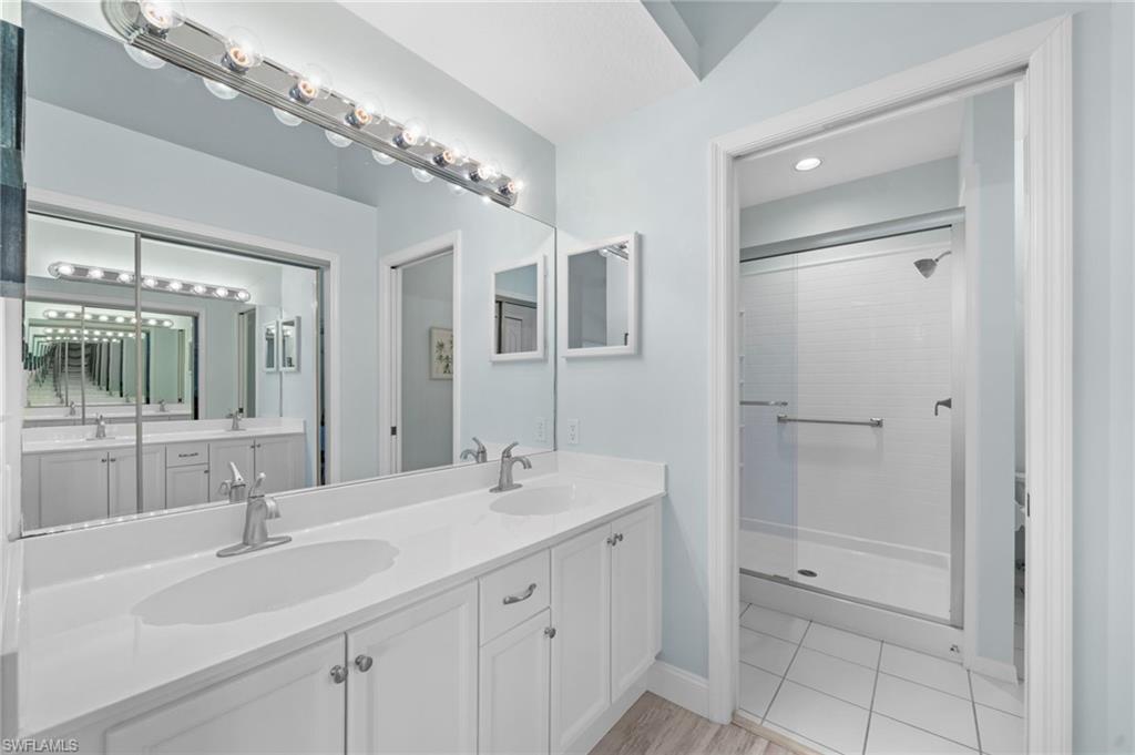 13120 Castle Harbour Drive, Unit N4 Naples, FL 34110 - Photo 18 of 36 a bathroom with a sink double vanity and a mirror