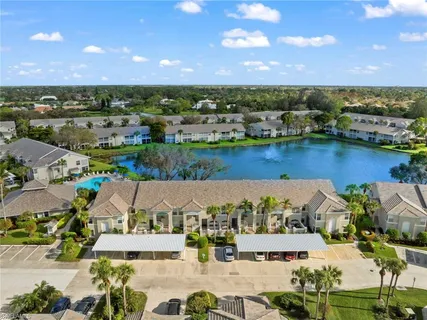 an aerial view of residential houses with outdoor space and ocean view