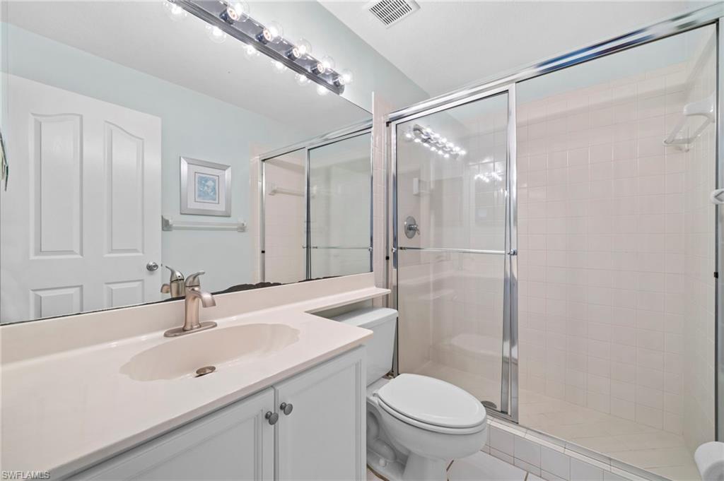 13120 Castle Harbour Drive, Unit N4 Naples, FL 34110 - Photo 22 of 36 a bathroom with a sink toilet and shower