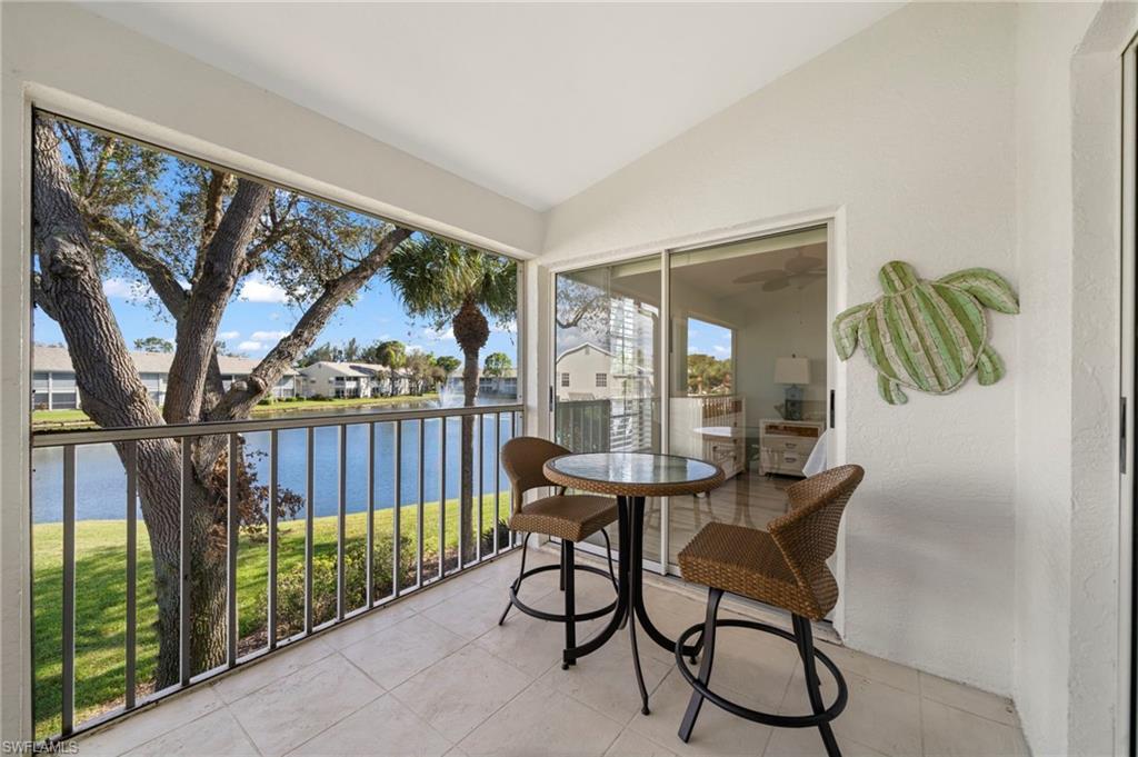 13120 Castle Harbour Drive, Unit N4 Naples, FL 34110 - Photo 25 of 36 a view of a porch with chairs and backyard