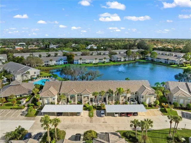 an aerial view of residential houses with outdoor space and ocean view