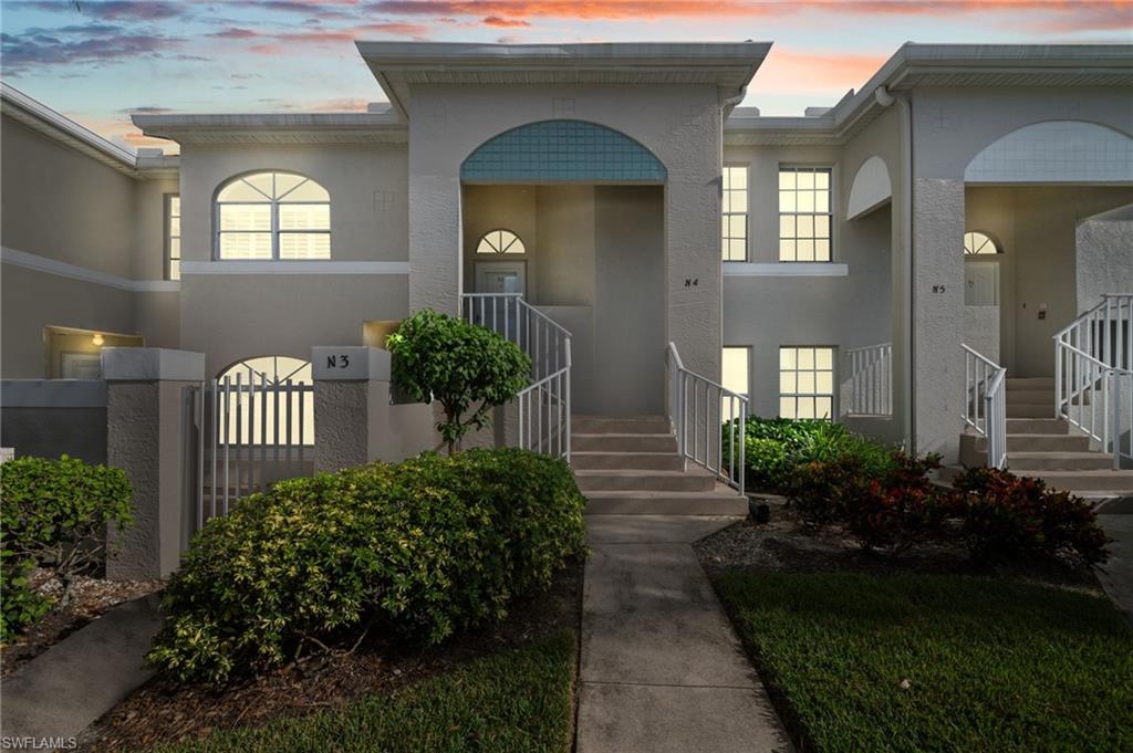 13120 Castle Harbour Drive, Unit N4 Naples, FL 34110 - Photo 32 of 36 a front view of a house with a yard