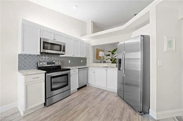 a kitchen with a refrigerator stove and sink