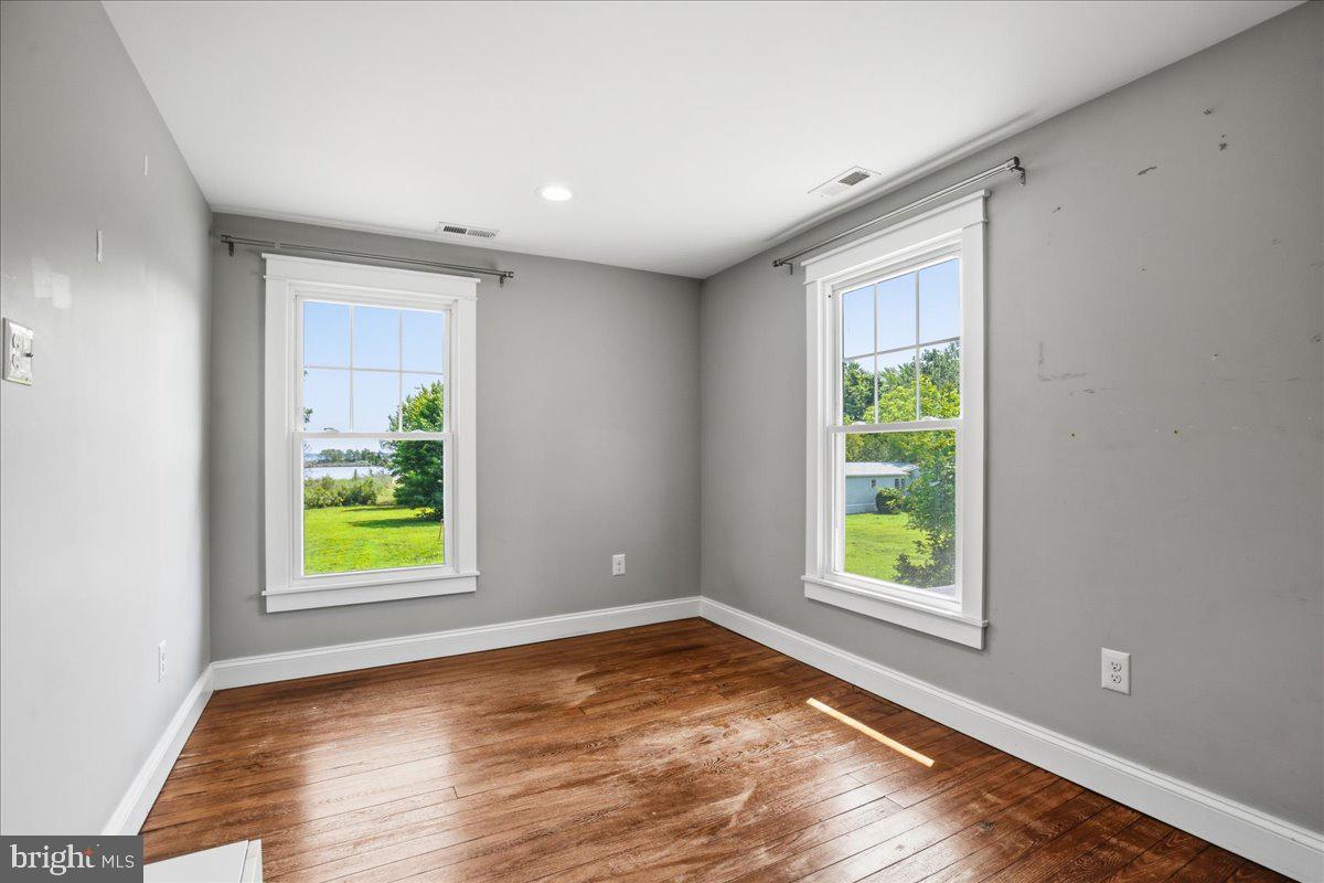 16146 Thomas Road Piney Point, MD 20674 - Photo 50 of 70 an empty room with windows and a bathtub