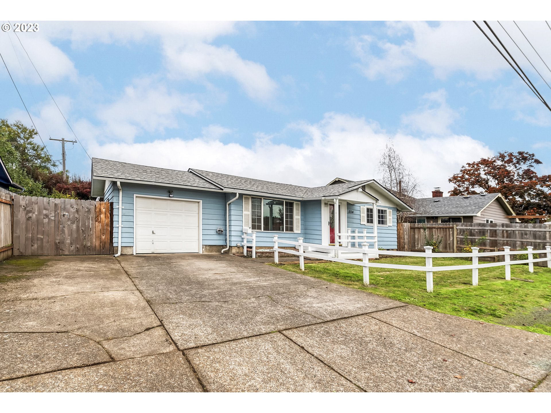 1234 21st Street Springfield, OR 97477 - Photo 1 of 28 a front view of a house with a yard and garage