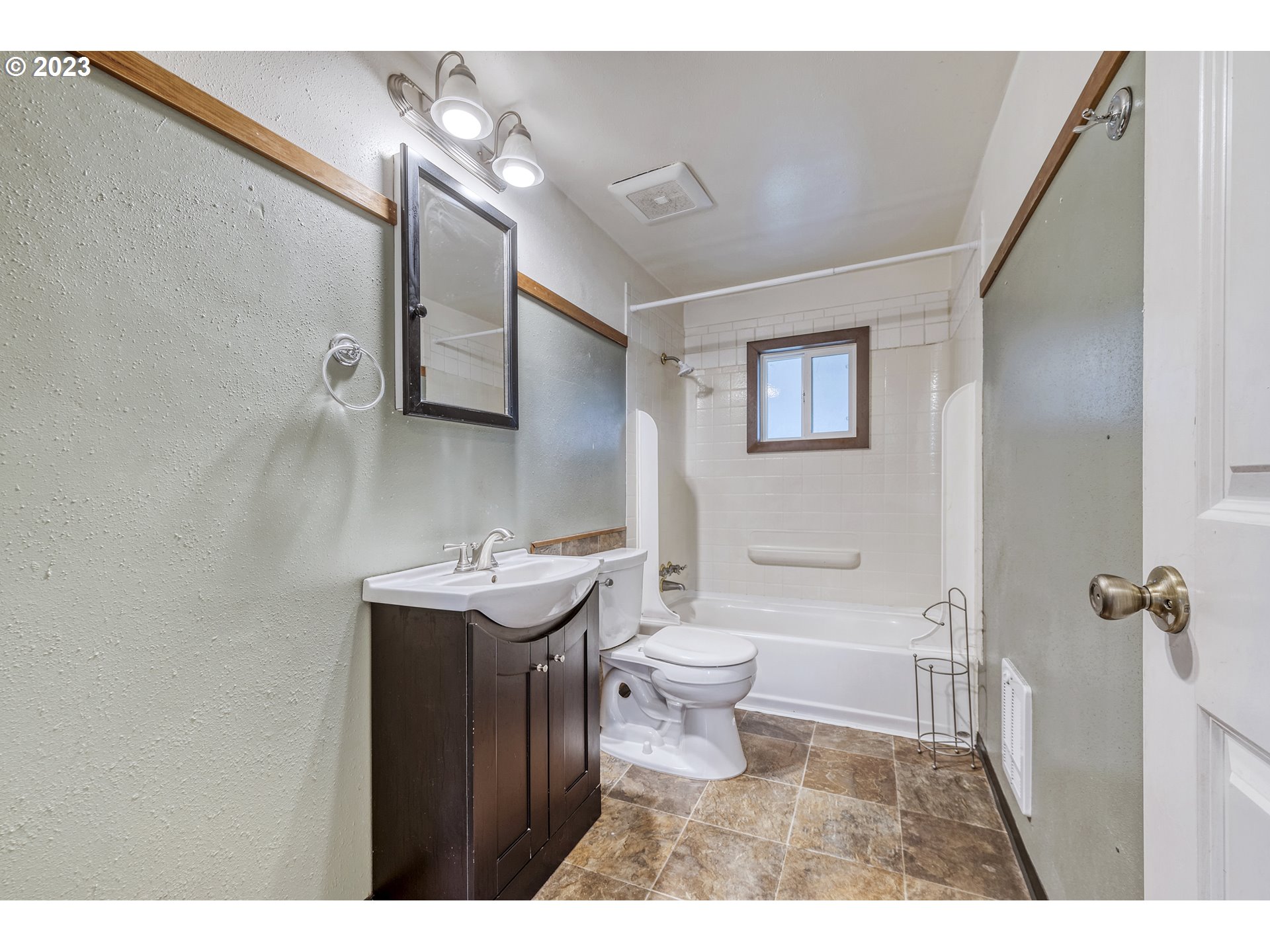 1234 21st Street Springfield, OR 97477 - Photo 12 of 28 a bathroom with a sink toilet a mirror and vanity