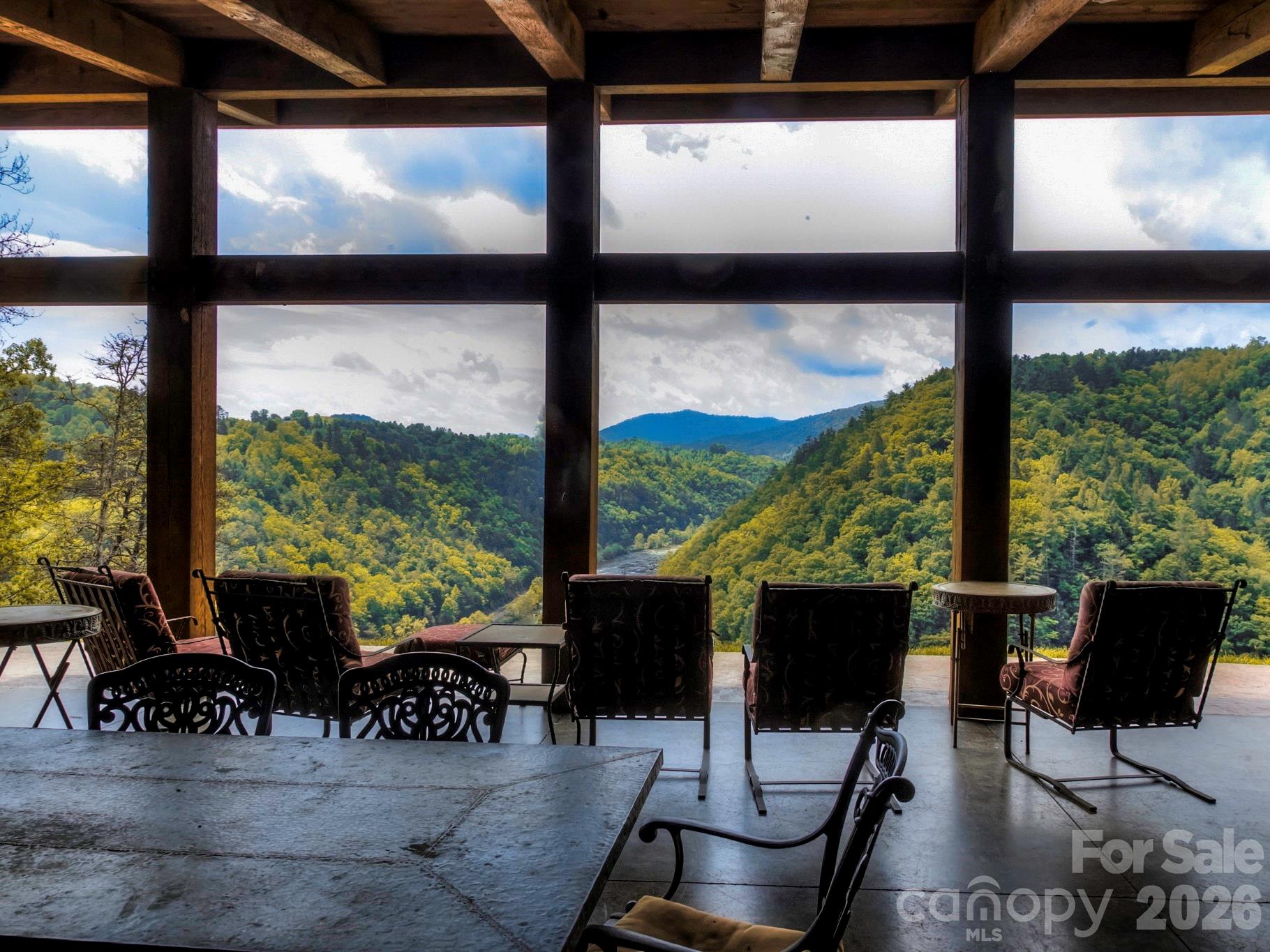 51 Wild Turkey Loop, Unit 32 Marshall, NC 28753 - Photo 28 of 37 a living room with patio furniture and a floor to ceiling window