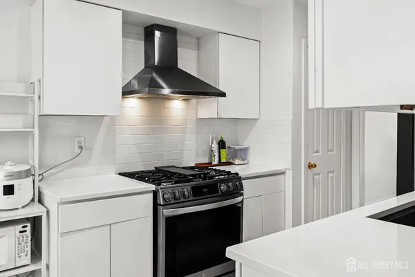 a kitchen with a stove and a refrigerator