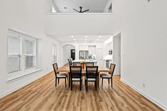 a dining room with furniture and wooden floor