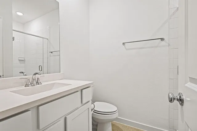 a bathroom with a sink toilet and vanity