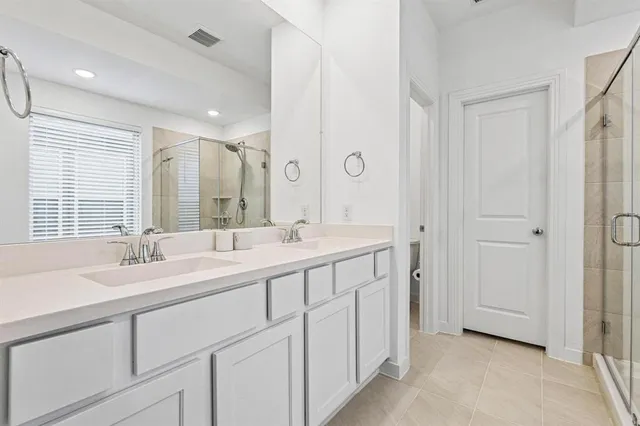 a spacious bathroom with a double vanity sink mirror and double