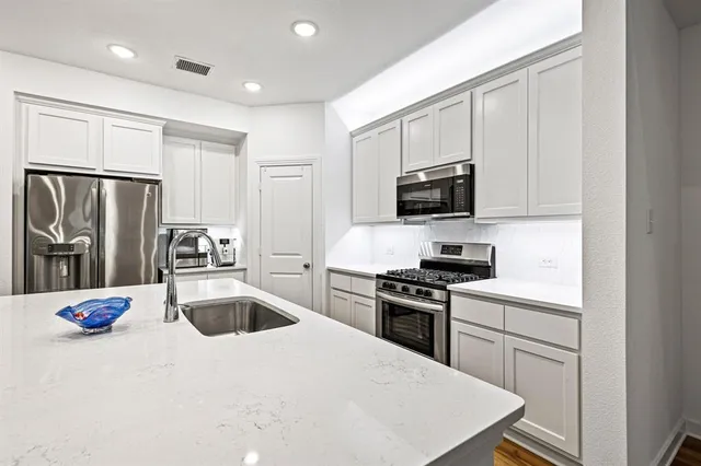 a kitchen with a refrigerator stove and microwave