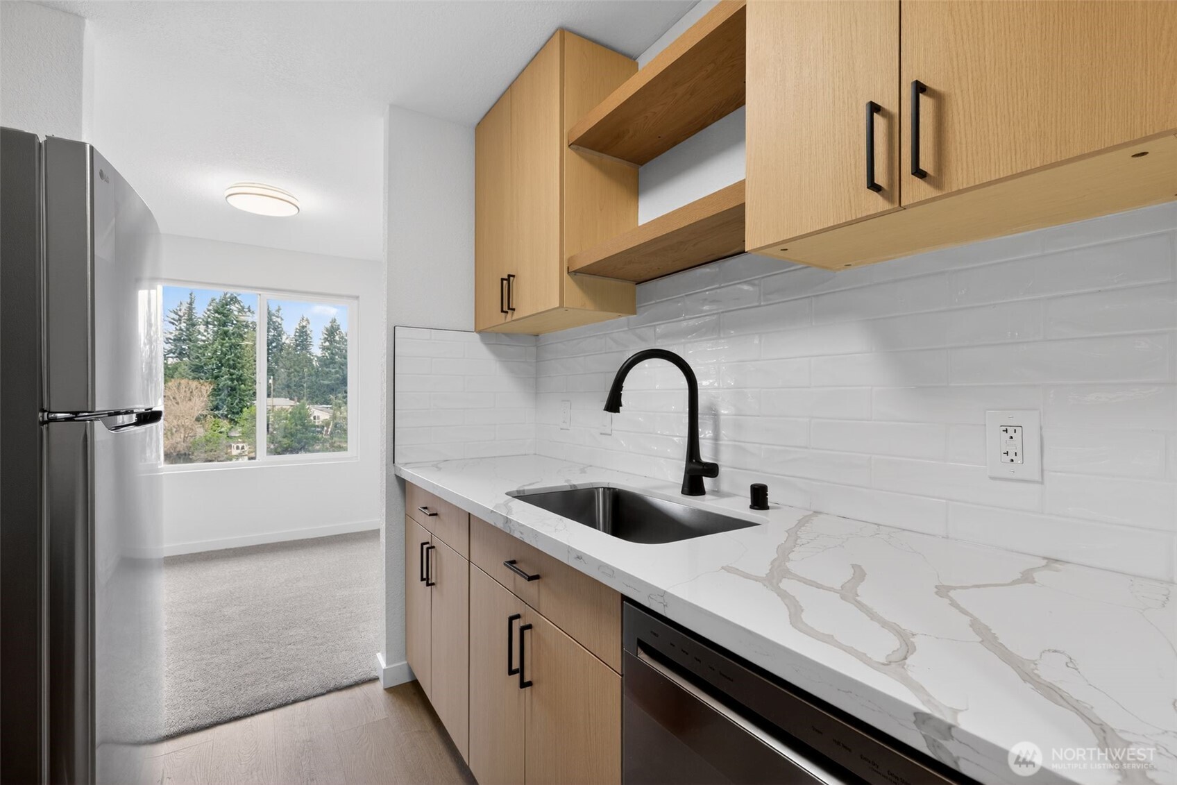 615 75th Street Southeast, Unit C53 Everett, WA 98203 - Photo 12 of 20 a kitchen with stainless steel appliances a sink a stove and a refrigerator
