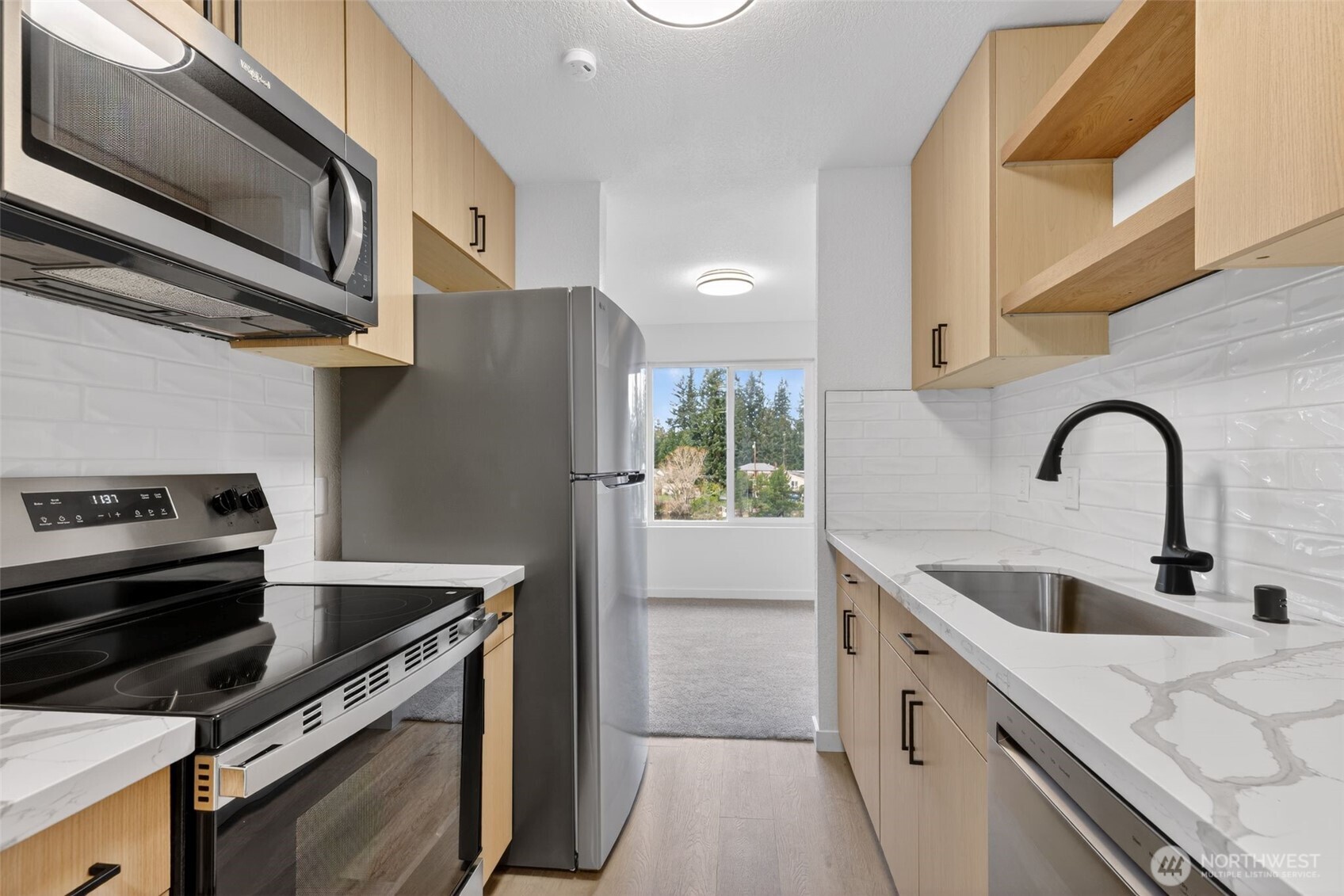 615 75th Street Southeast, Unit C53 Everett, WA 98203 - Photo 13 of 20 a kitchen with stainless steel appliances granite countertop a sink and a stove top oven