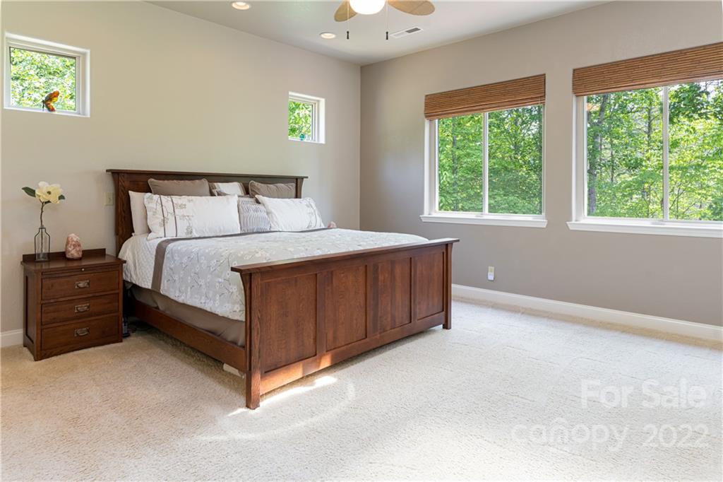 2391 Paint Fork Road Mars Hill, NC 28754 - Photo 11 of 45 a bed sitting in a bedroom next to a window