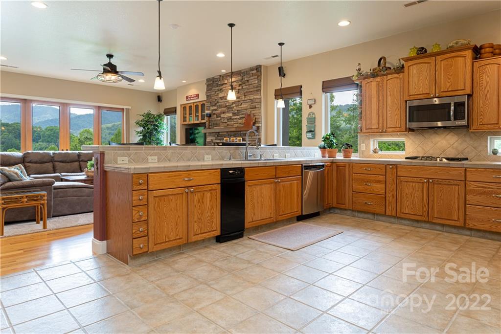 2391 Paint Fork Road Mars Hill, NC 28754 - Photo 21 of 45 a large kitchen with stainless steel appliances lots of counter space sink and cabinets