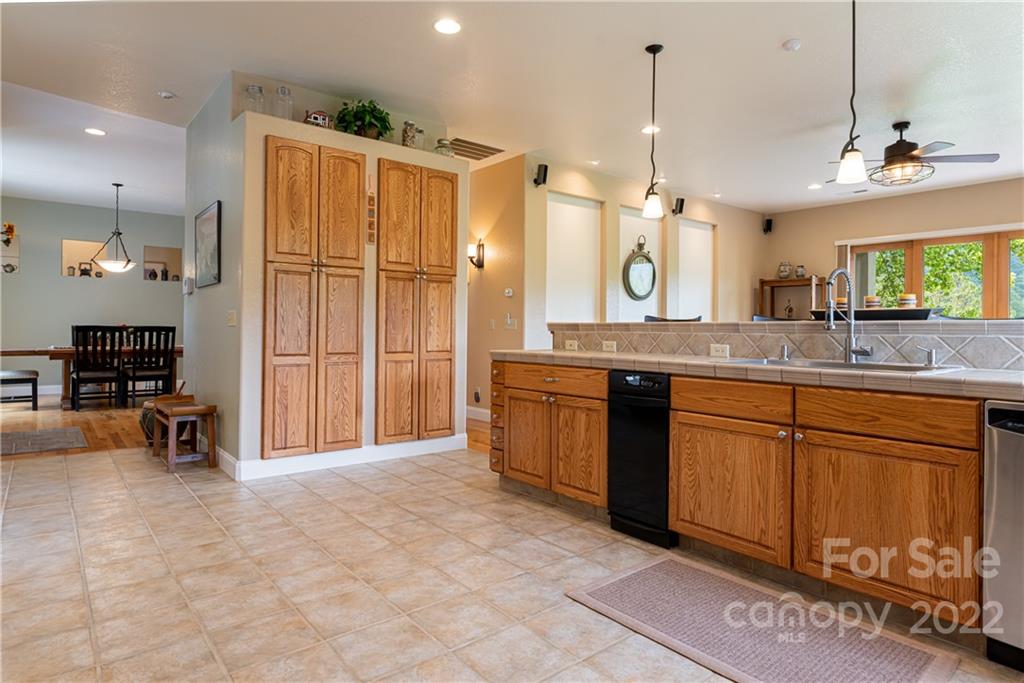 2391 Paint Fork Road Mars Hill, NC 28754 - Photo 22 of 45 a spacious kitchen with stainless steel appliances granite countertop a sink and a refrigerator