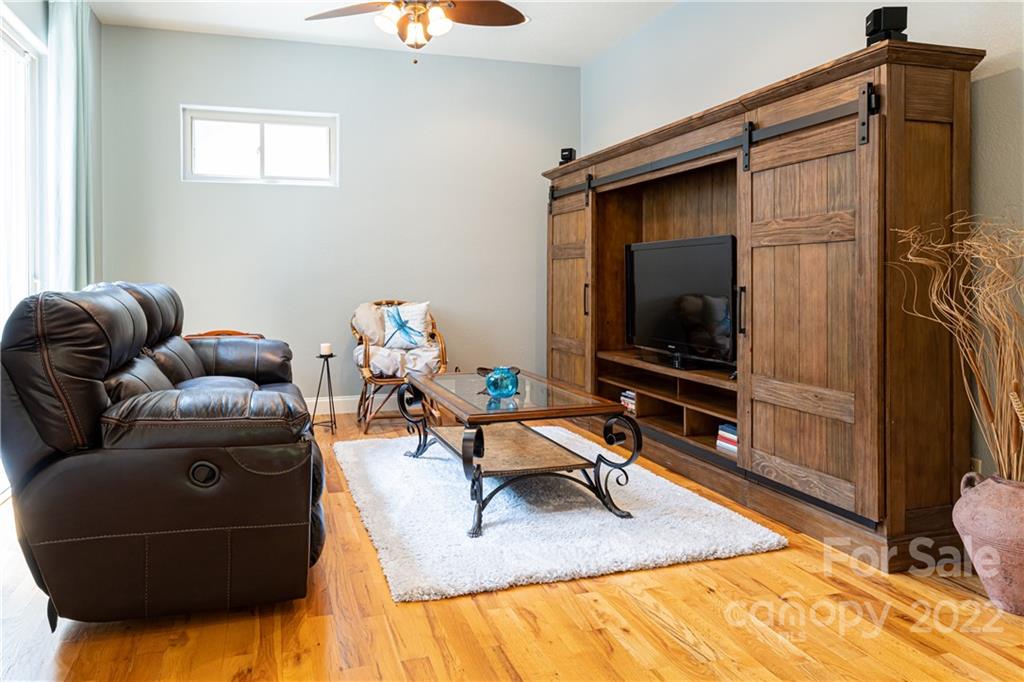 2391 Paint Fork Road Mars Hill, NC 28754 - Photo 28 of 45 a living room with furniture and a flat screen tv