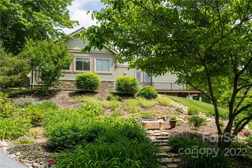 2391 Paint Fork Road Mars Hill, NC 28754 - Photo 3 of 45 a view of a garden with a tree in front of the house