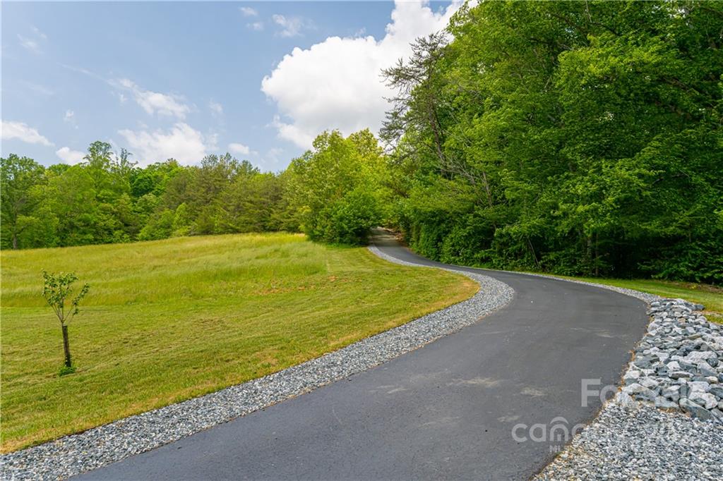 2391 Paint Fork Road Mars Hill, NC 28754 - Photo 45 of 45 a view of a large swimming pool and trees in the background