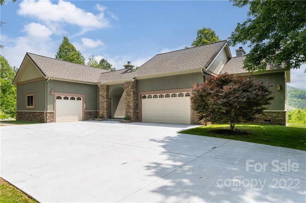 2391 Paint Fork Road Mars Hill, NC 28754 - Photo 5 of 45 a front view of a house with a yard and garage