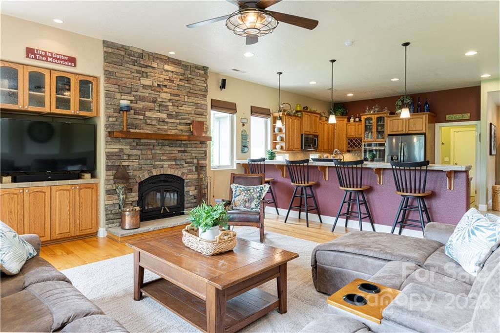 2391 Paint Fork Road Mars Hill, NC 28754 - Photo 9 of 45 a living room with furniture a flat screen tv and a fireplace