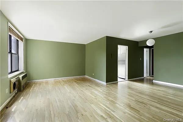 wooden floor in an empty room with a window