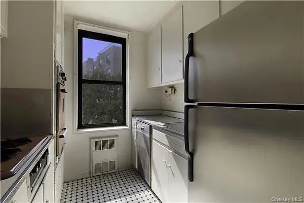a kitchen with a refrigerator and a stove