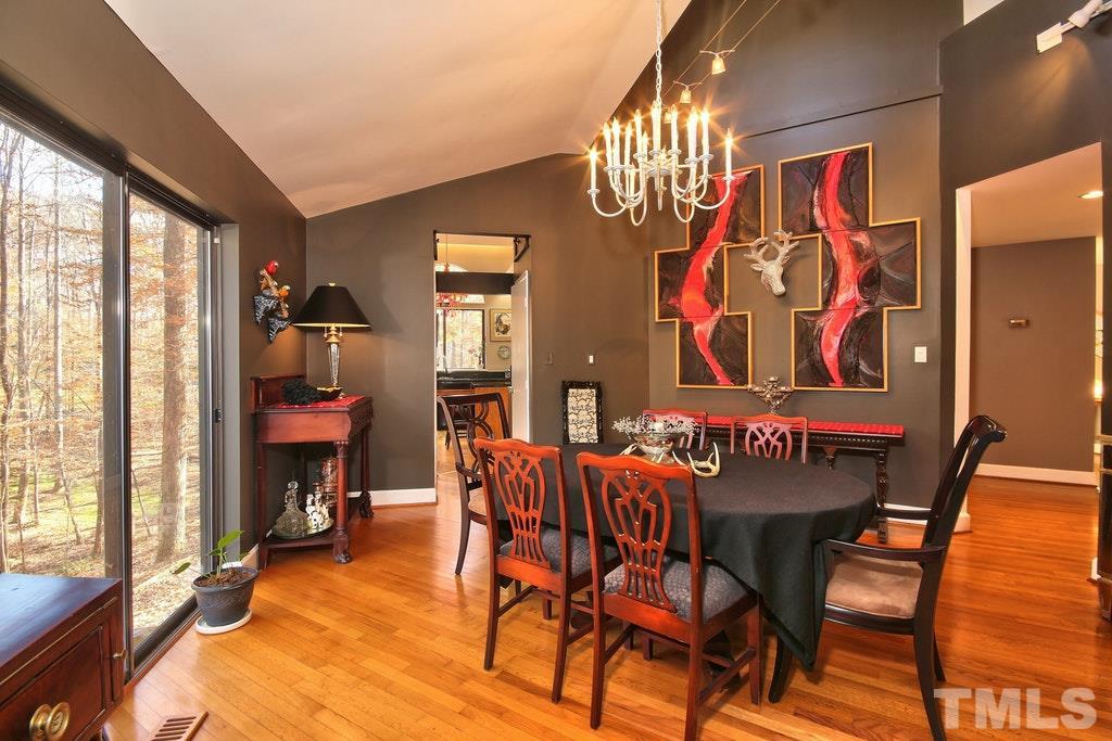 11312 Saddleview Court Raleigh, NC 27613 - Photo 11 of 25 VERY big and a great room to host a dinner party. Easily fit a table that seats 15 in here with plenty of leftover space. Overlooks the partially cleared back yard via a huge sliding glass window. Hardwoods continue.