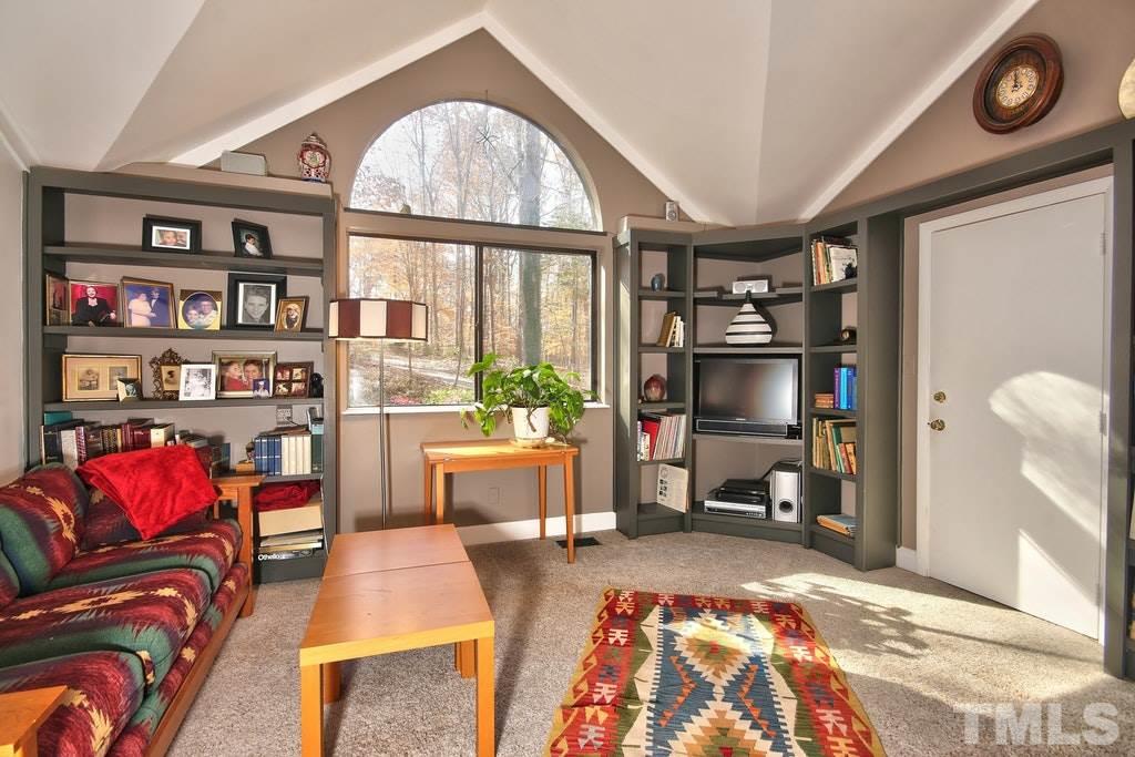 11312 Saddleview Court Raleigh, NC 27613 - Photo 14 of 25 Showcase your family or friend photos or your collectibles on the vast built in shelving! Arched ceiling and stair accessible to the walk in attic that is floored.