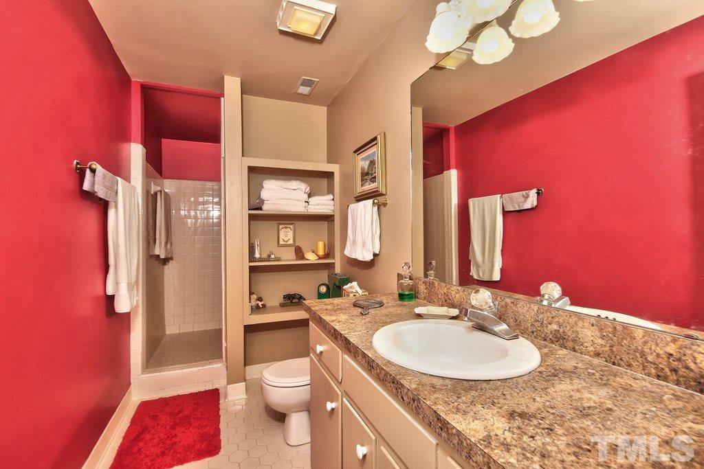 11312 Saddleview Court Raleigh, NC 27613 - Photo 19 of 25 Great counter space so no fighting over it! Single vanity and ceramic tiled HUGE walk in shower. Very spacious walk in closet.
