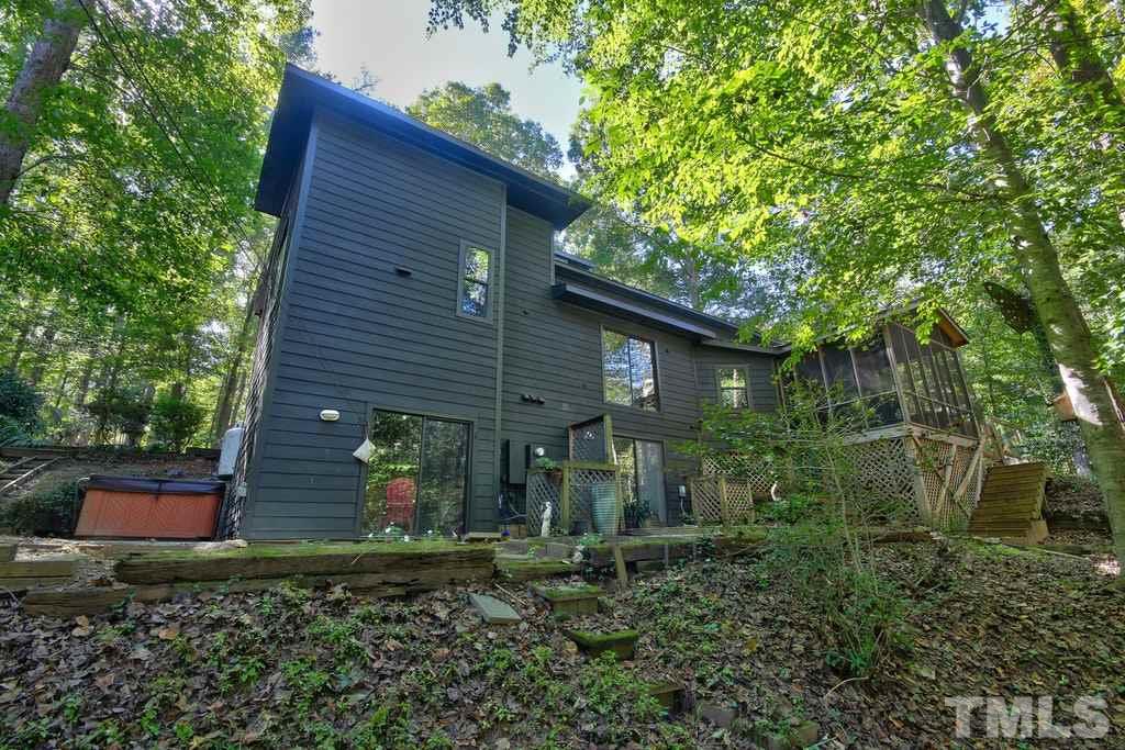 11312 Saddleview Court Raleigh, NC 27613 - Photo 22 of 25 Wonderful backyard is partially cleared and still features nature's beauty! Take in the stars while relaxing in your hot tub outside of the master bedroom.
