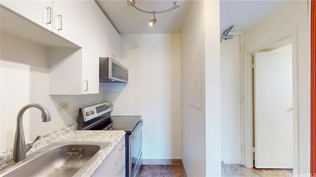 a close view of a sink and a microwave in a kitchen
