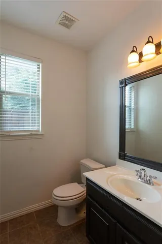 a bathroom with a sink toilet and mirror