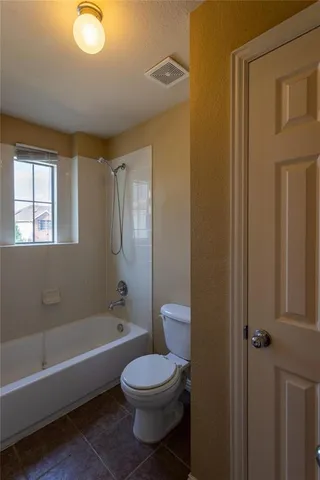 a bathroom with a toilet a sink and bathtub