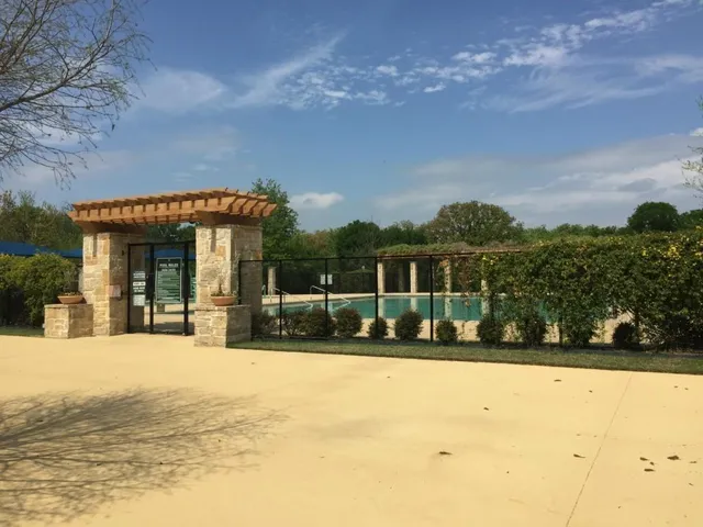 a view of a house with a yard covered with snow in the background