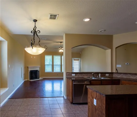a view of a kitchen with granite countertop a stove top oven
