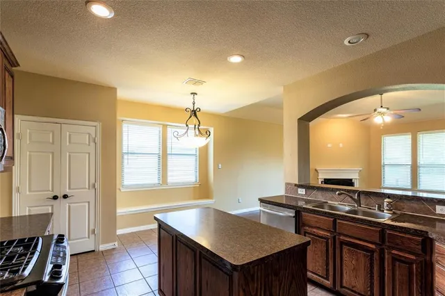 a kitchen with a stove a sink and a refrigerator